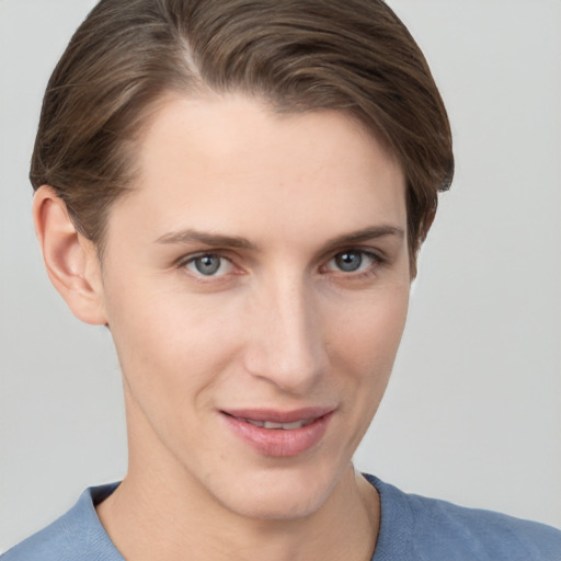 Joyful white young-adult female with short  brown hair and grey eyes