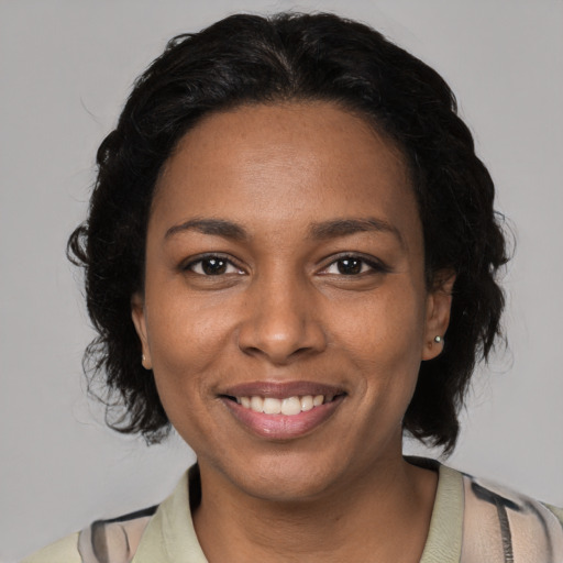 Joyful black young-adult female with medium  black hair and brown eyes
