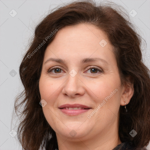 Joyful white adult female with long  brown hair and brown eyes