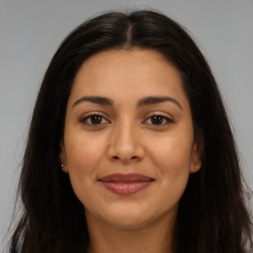 Joyful latino young-adult female with long  brown hair and brown eyes