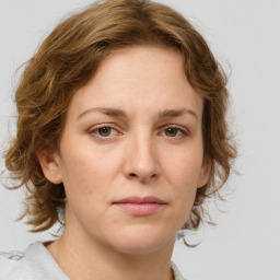 Joyful white young-adult female with medium  brown hair and green eyes