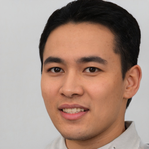 Joyful asian young-adult male with short  black hair and brown eyes