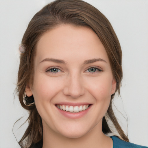 Joyful white young-adult female with medium  brown hair and grey eyes