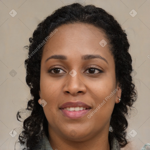 Joyful black young-adult female with long  brown hair and brown eyes