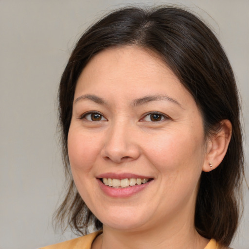Joyful white adult female with medium  brown hair and brown eyes