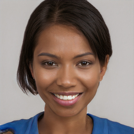 Joyful black young-adult female with medium  brown hair and brown eyes