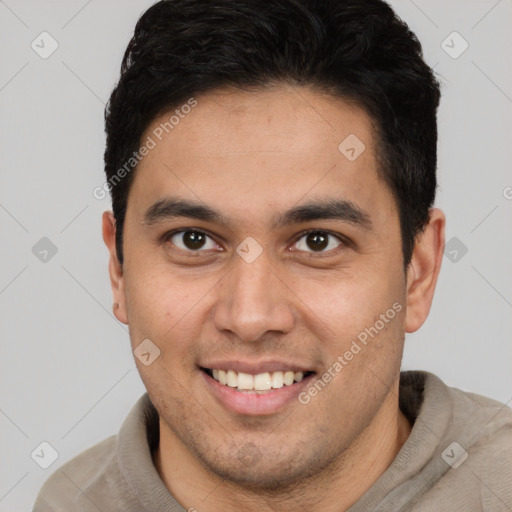 Joyful latino young-adult male with short  brown hair and brown eyes