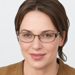 Joyful white young-adult female with medium  brown hair and blue eyes