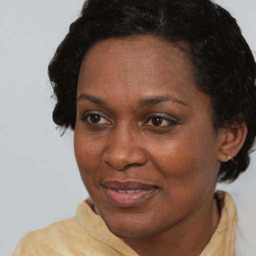 Joyful black adult female with short  brown hair and brown eyes
