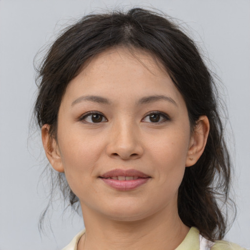 Joyful asian young-adult female with medium  brown hair and brown eyes