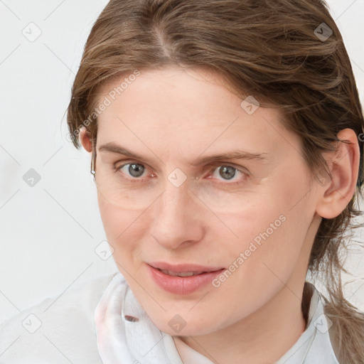 Joyful white young-adult female with medium  brown hair and grey eyes