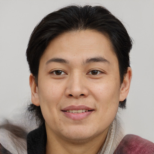Joyful asian young-adult male with medium  brown hair and brown eyes