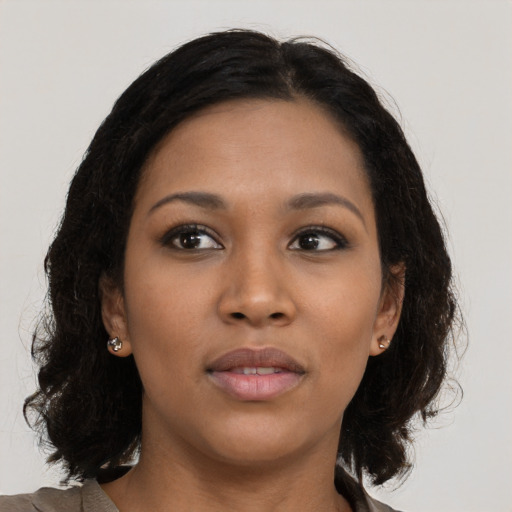 Joyful black young-adult female with medium  brown hair and brown eyes