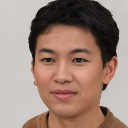 Joyful asian young-adult male with short  brown hair and brown eyes