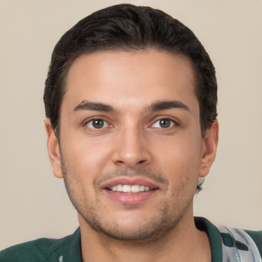 Joyful white young-adult male with short  brown hair and brown eyes