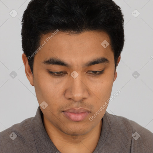 Joyful asian young-adult male with short  black hair and brown eyes