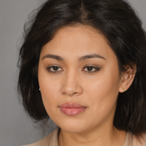 Joyful asian young-adult female with long  brown hair and brown eyes