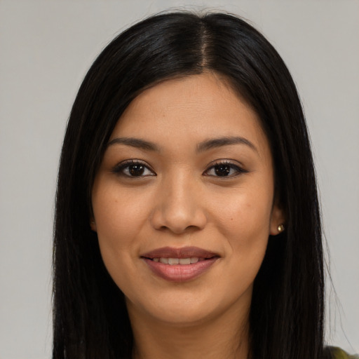 Joyful latino young-adult female with long  black hair and brown eyes