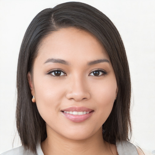 Joyful white young-adult female with long  brown hair and brown eyes