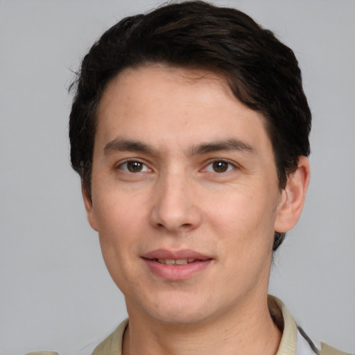 Joyful white young-adult male with short  black hair and brown eyes