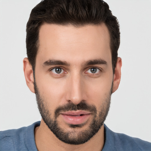 Joyful white young-adult male with short  black hair and brown eyes