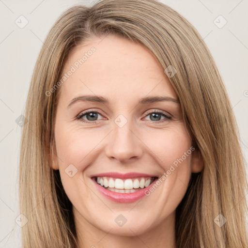 Joyful white young-adult female with long  brown hair and green eyes