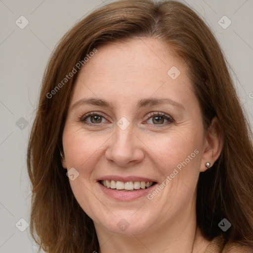 Joyful white adult female with long  brown hair and grey eyes