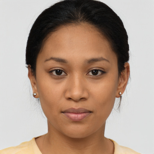 Joyful latino young-adult female with short  black hair and brown eyes