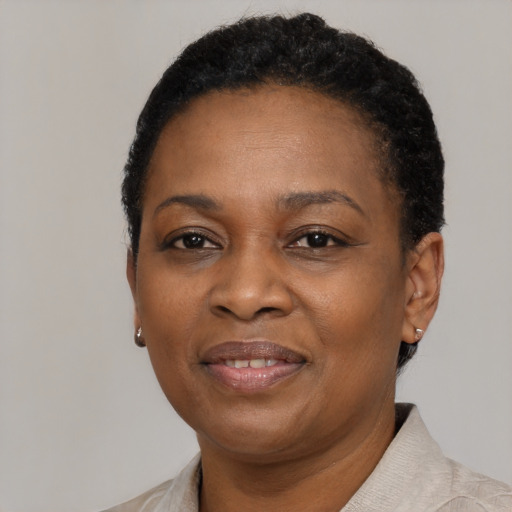Joyful black adult female with short  black hair and brown eyes