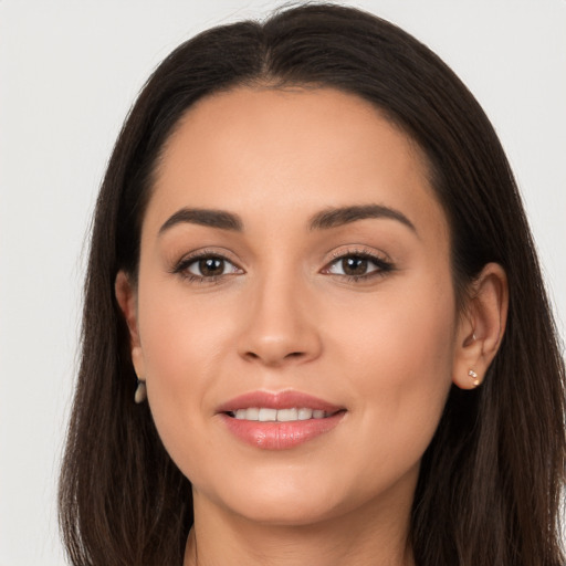 Joyful white young-adult female with long  brown hair and brown eyes