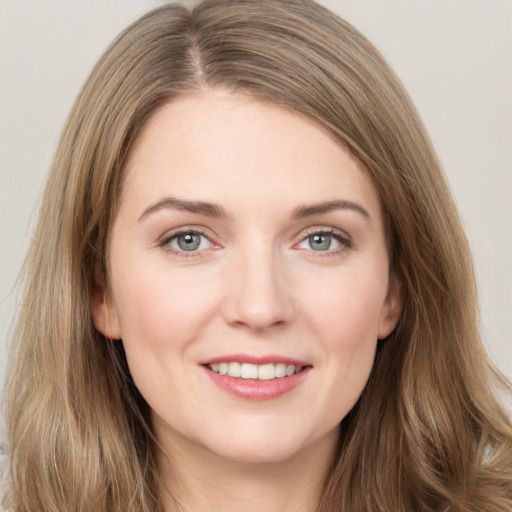 Joyful white young-adult female with long  brown hair and grey eyes