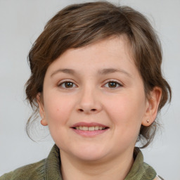 Joyful white child female with medium  brown hair and grey eyes