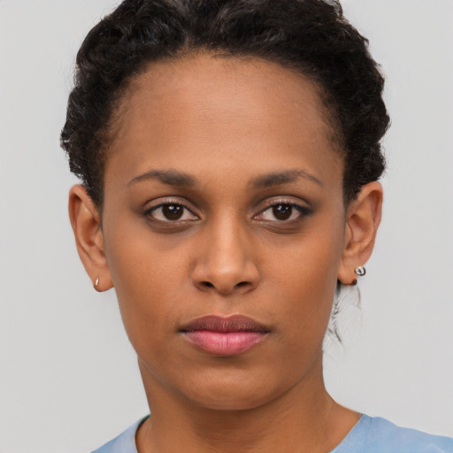 Joyful black young-adult female with short  brown hair and brown eyes