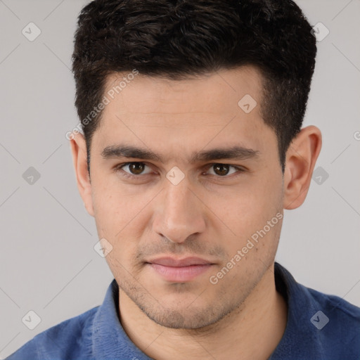 Joyful white young-adult male with short  black hair and brown eyes