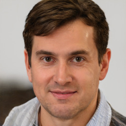 Joyful white adult male with short  brown hair and brown eyes