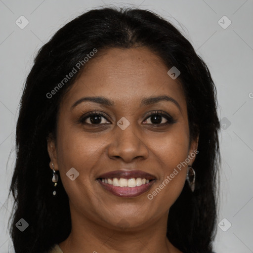 Joyful black young-adult female with long  brown hair and brown eyes