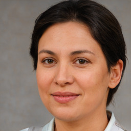 Joyful white adult female with medium  brown hair and brown eyes