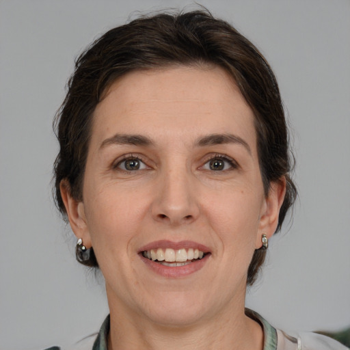 Joyful white adult female with medium  brown hair and brown eyes