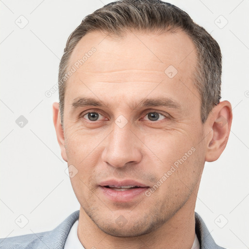 Joyful white adult male with short  brown hair and brown eyes