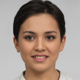 Joyful white young-adult female with short  brown hair and brown eyes