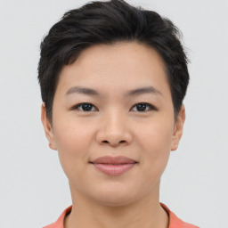 Joyful asian young-adult female with short  brown hair and brown eyes