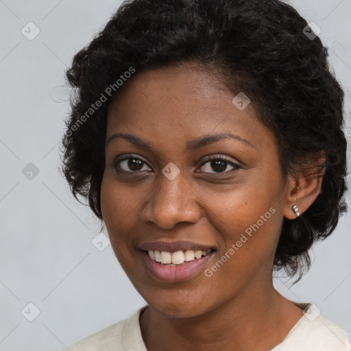 Joyful black young-adult female with short  brown hair and brown eyes