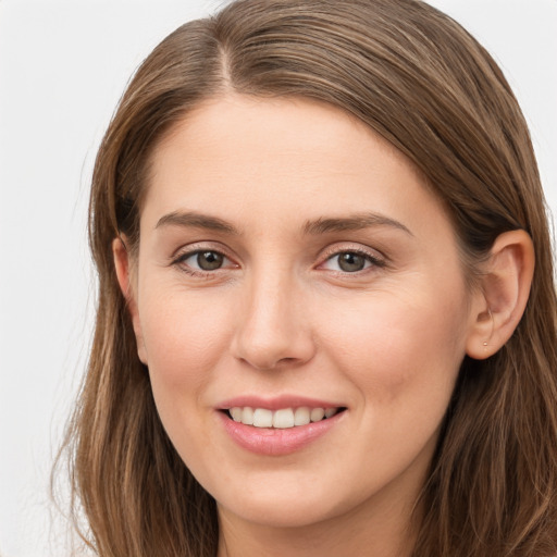 Joyful white young-adult female with long  brown hair and grey eyes