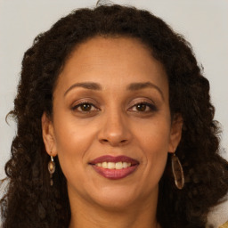 Joyful white adult female with long  brown hair and brown eyes