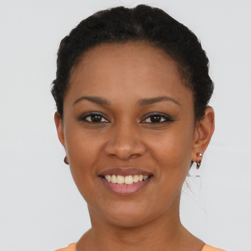 Joyful black young-adult female with short  brown hair and brown eyes