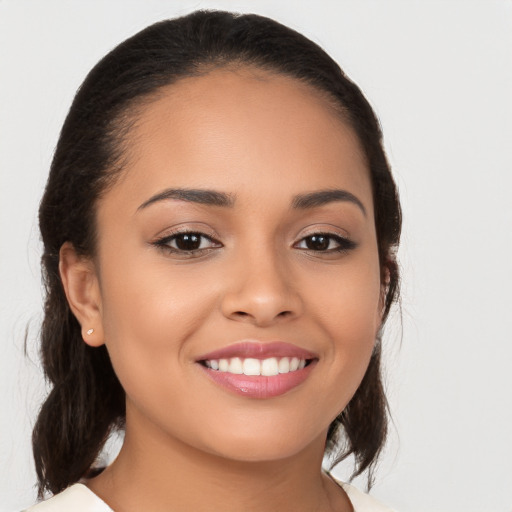 Joyful latino young-adult female with medium  brown hair and brown eyes