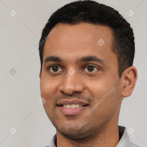 Joyful white young-adult male with short  black hair and brown eyes