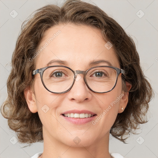 Joyful white adult female with medium  brown hair and blue eyes