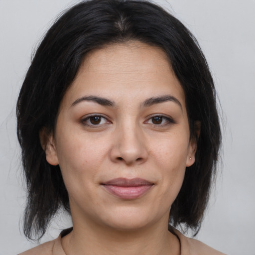 Joyful asian young-adult female with medium  brown hair and brown eyes