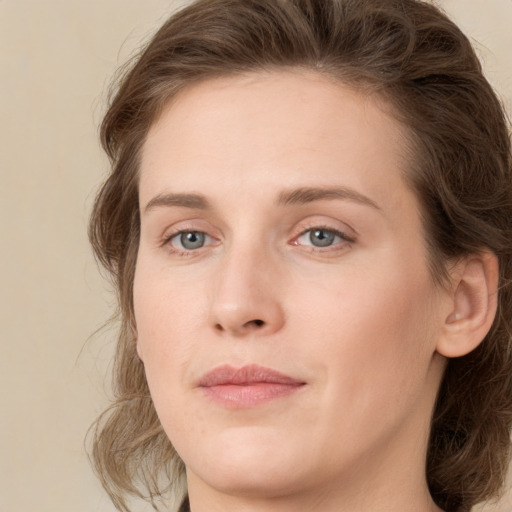 Joyful white young-adult female with medium  brown hair and green eyes